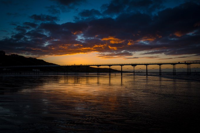 Beautiful Tim Hill photograph of the sun setting over the coast at Saltburn and the only remaining pleasure pier between the Tees and the Humber image Public Domain