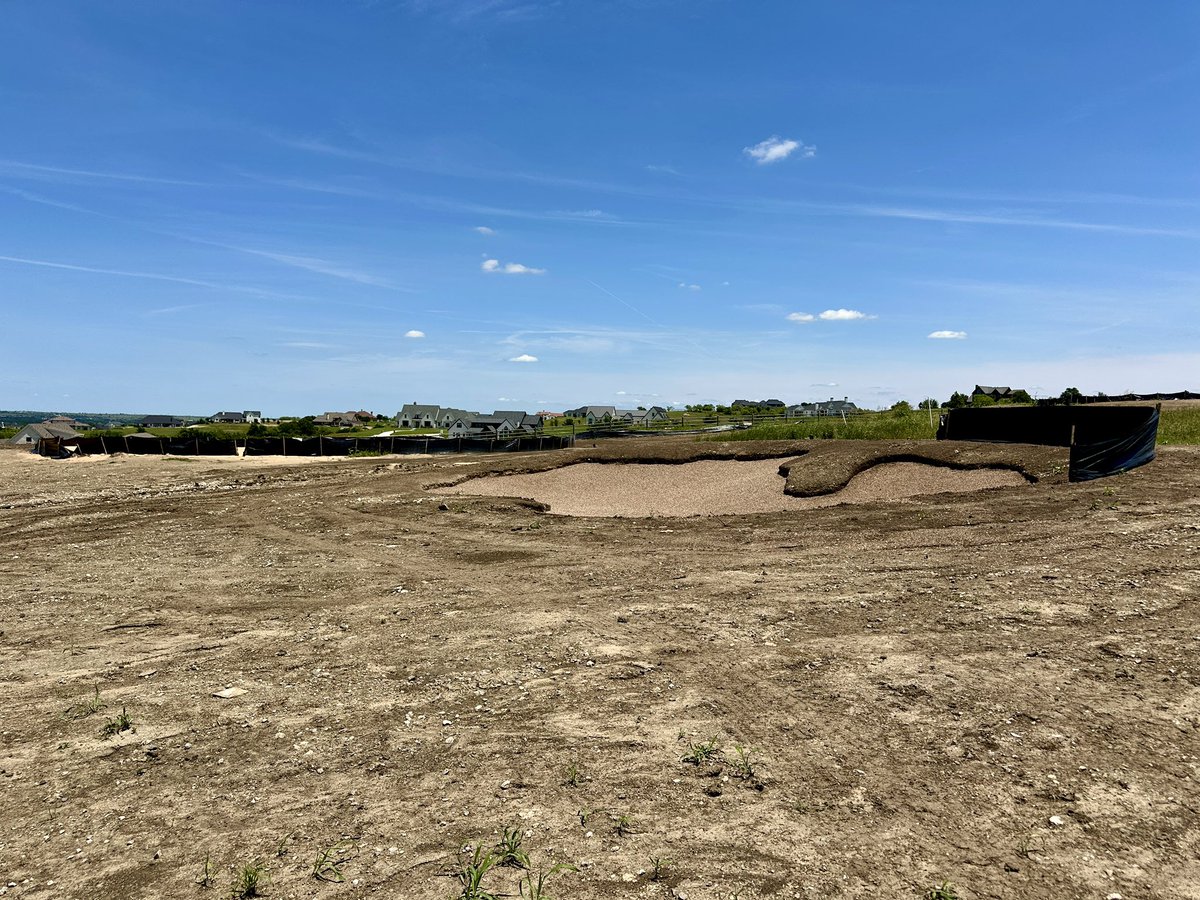 Touching up the bunkers after heavy rain earlier this week.