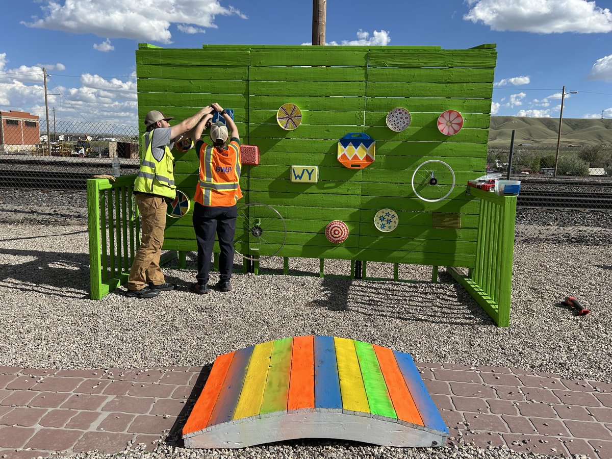 TWEProject's tweet photo. A beautiful Downtown Rawlins, Wyoming, cleanup day today with our construction partner Barnard Wilson Joint Venture joining the volunteer team - painting a creative safety crosswalk over to the Depot’s Kids Korner, designing a “music wall,” weeding and so much more. https://t.co/8DCYa8dIGP