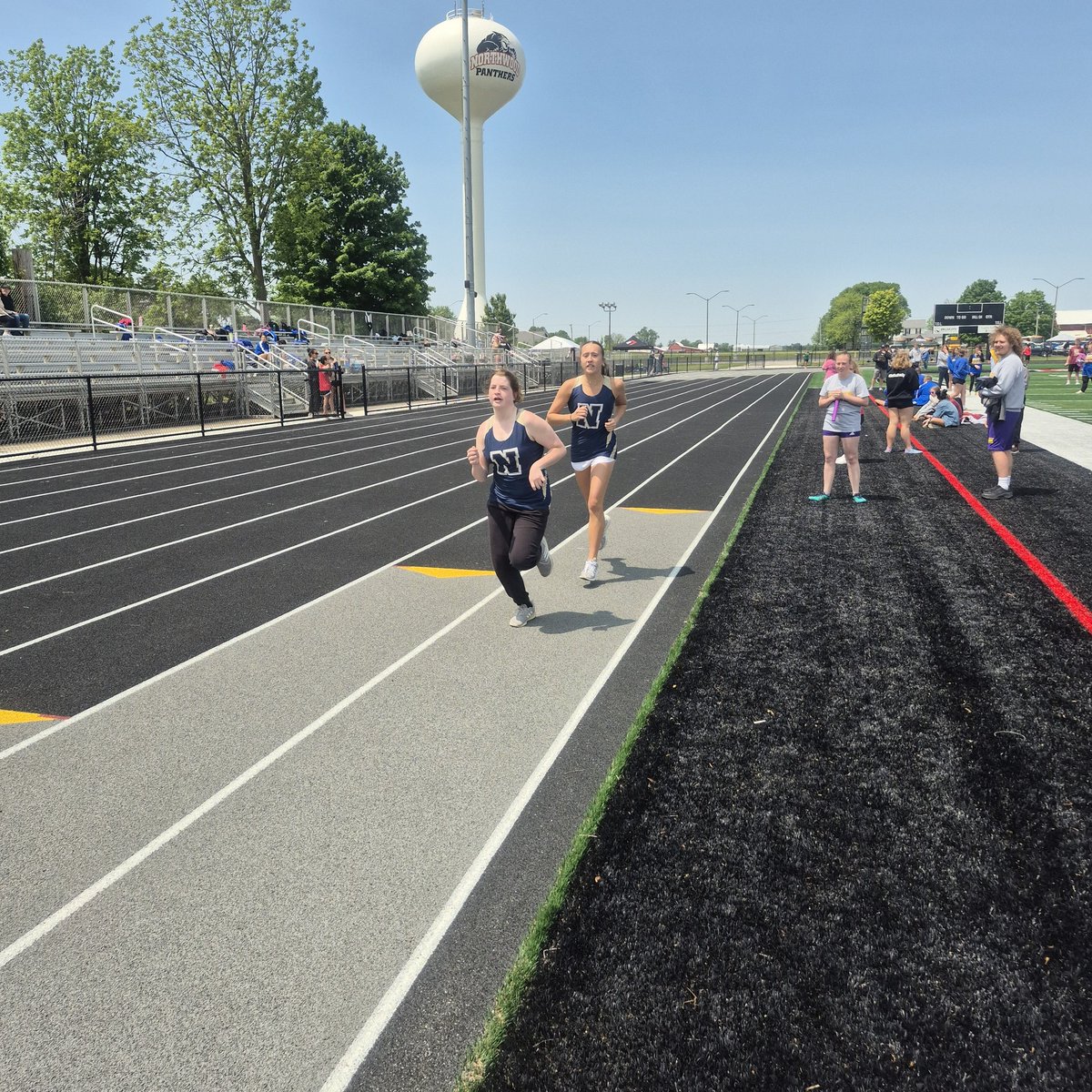 Michael Long and Ada McLaughlin running the 400. Connor and Avery encouraging them around the track! Unified Knights!