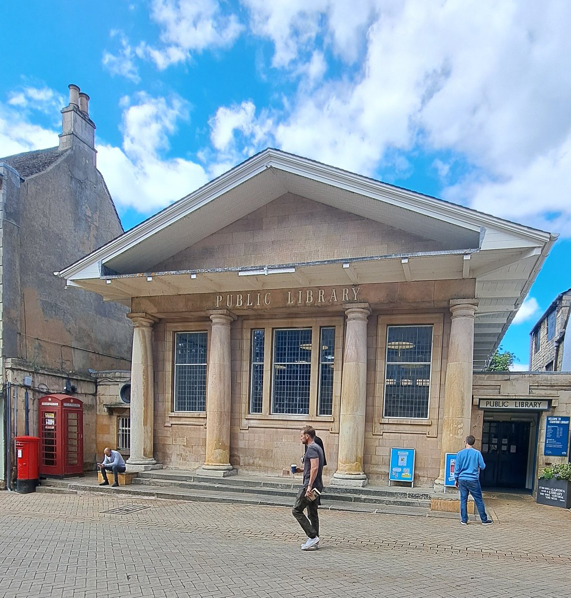 A bit of a shambles. This portico in Stamford High St resembles Inigo Jones's St Paul's Covent Garden. Designed William Legg; built  1804 as entrance to shambles (butchers' stalls) with open front. In 1906,  enclosed as public library. Listed Grade II, as is phone box beside it.