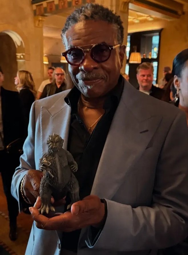 Kaibrex's tweet image. Keith David holding an X-Plus Godzilla figure