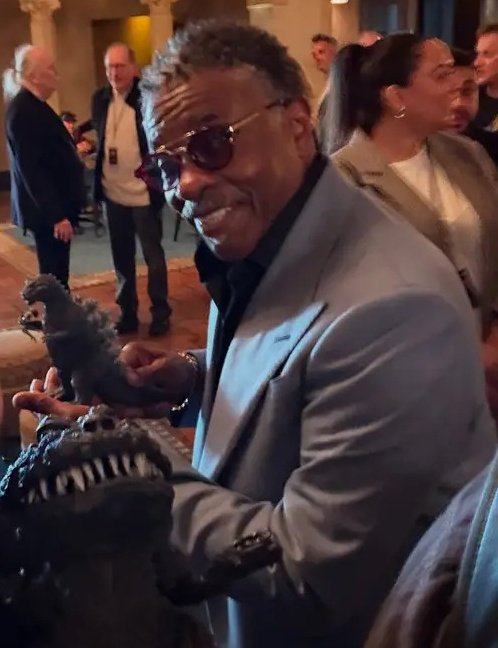Kaibrex's tweet image. Keith David holding an X-Plus Godzilla figure
