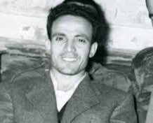 MOuerthi's tweet image. For those who don't understand the importance of the smile, she announced it before the kidnapping, she's emulating Larbi Ben M'hidi an Algerian resistance fighter who refused to show himself bowing or be defeated by the colonisers. 
He faced the execution with a smile, unbroken.