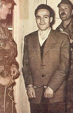 MOuerthi's tweet image. For those who don't understand the importance of the smile, she announced it before the kidnapping, she's emulating Larbi Ben M'hidi an Algerian resistance fighter who refused to show himself bowing or be defeated by the colonisers. 
He faced the execution with a smile, unbroken.