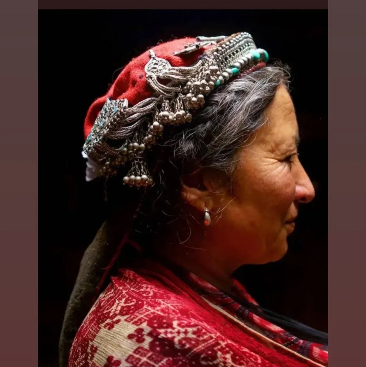 Balti woman from Turtuk graces the frame, adorned with a traditional Balti Yutu, a ceremonial Yutu (cap) meticulously crafted from wool and embellished with silk-thread embroidery and ornate silver jewelry, known as zbra, phandil. Courtesy: Balti Heritage &amp; Museum, Turtuk .
