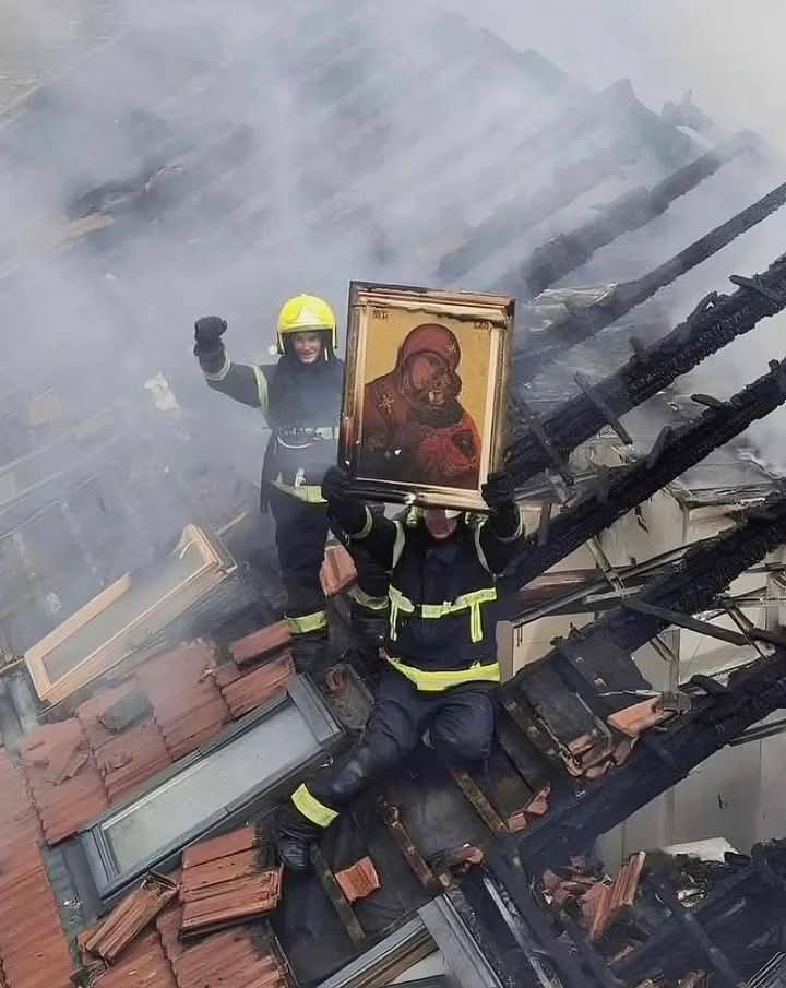 In Ruma, Serbia, firefighters celebrate on the roof after they discover a painting of Mary, the mother of Jesus, that remained in one piece after extinguishing a house fire which destroyed the building.