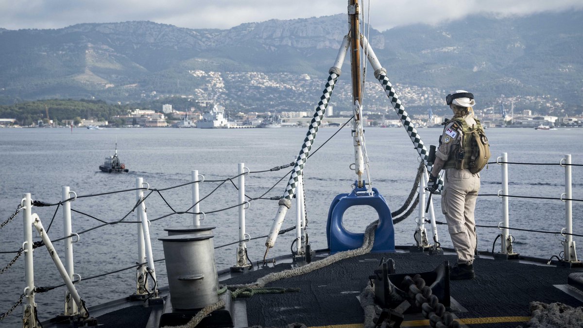 Sailor First Class Melissa Boivin, a member of HMCS Charlottetown's Naval Boarding Party, conducts force protection duties on the foc'sle of the ship upon arrival at Toulon Naval Base in Toulon, France, during a scheduled port visit during Operation REASSURANCE on 26 June 2024.