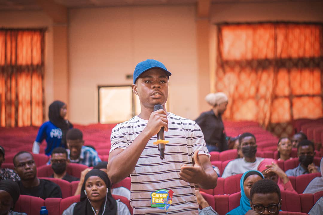 SundayOdafe1's tweet photo. One year ago, I was just another face in the crowd at a similar event. Sitting in that same auditorium, taking notes, dreaming big.
Today, I stood backstage as the Design Lead, watching that same auditorium packed beyond capacity. The transformation was surreal. ✨ https://t.co/QzWJTHHFj5