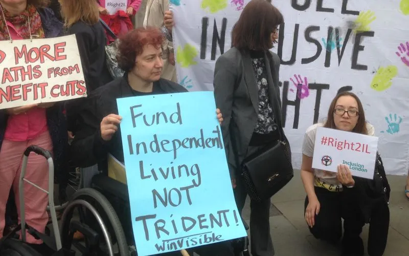 WinVisibleWomen's tweet photo. Old photo: we've protested to #ScrapTrident for years! £200 billion on nuclear warhead submarines could instead fund disability benefits & decent benefits, support independent living, feed children, pay mothers and family carers... #WelfareNotWarfare https://t.co/7MghH82zTJ https://t.co/s4Q7SIPNyP