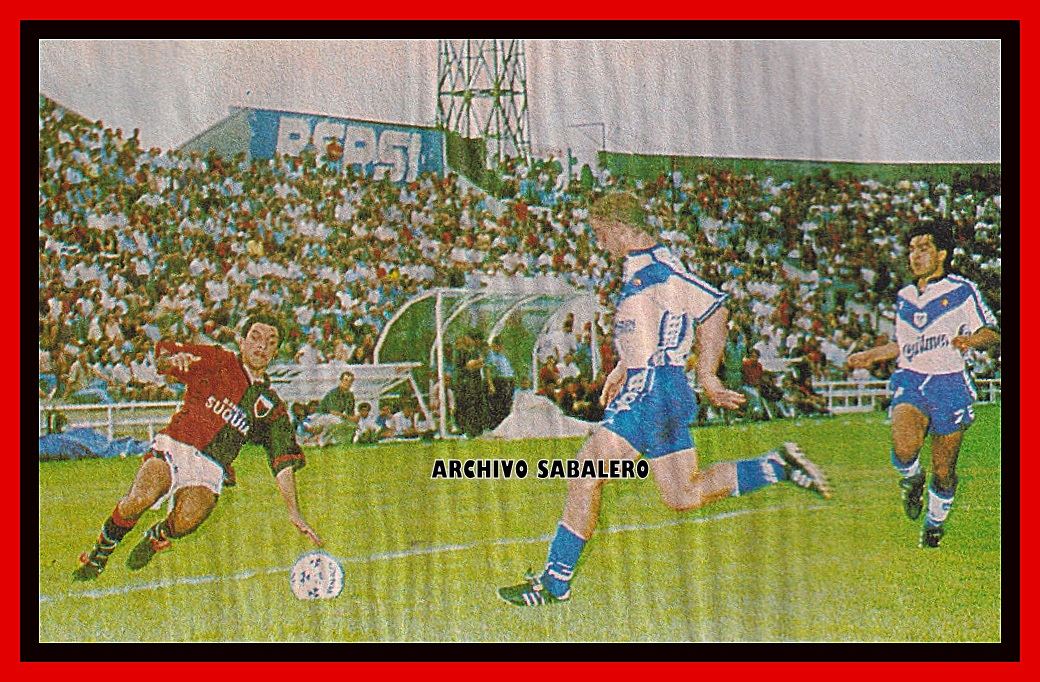Claudio Marini, por tirarse a barrer la pelota. De fondo, el sector noroeste. Se puede apreciar una de las viejas torres de iluminación y antiguos bancos de suplentes. Colón 1-1 Vélez, Apertura 1997.