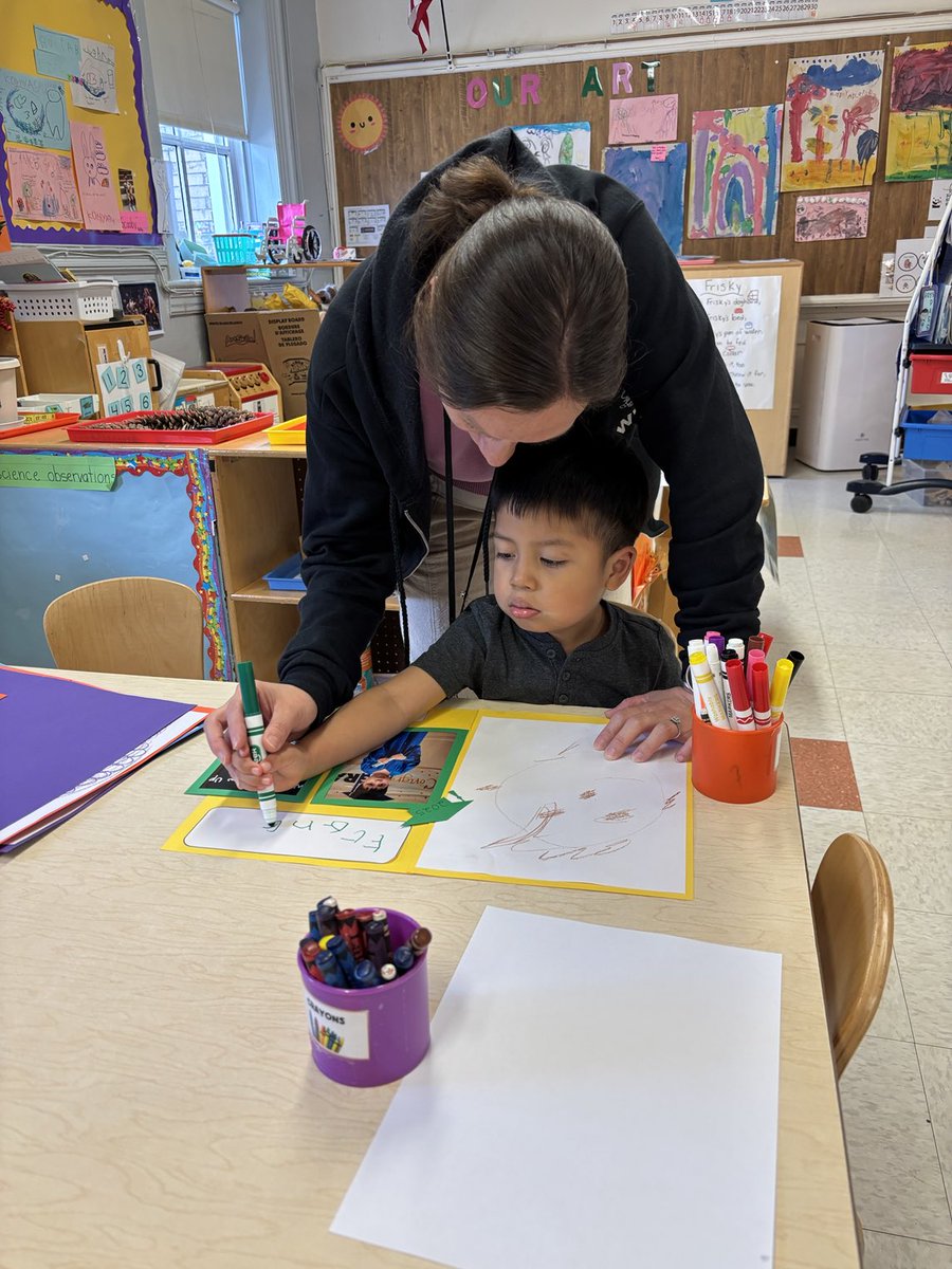 Annex 4- Miss Jessica is assisting a student with moving up ceremony work!  ⁦<a href="/wnyecc/">WNYECC</a>⁩ ⁦<a href="/WestNYSchools/">West New York School District</a>⁩
