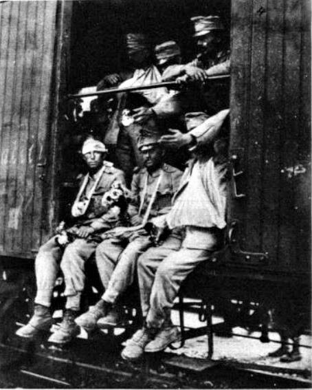 Left: Smiling Austro-Hungarian soldiers waiting to be transported to Galicia by train. Right: Wounded soldiers return from the fighting near Lemberg in Galicia just a few weeks later. The Battle of Galicia (23 Aug.-11 Sept., 1914) cost Austria-Hungary some 400,000 casualties.