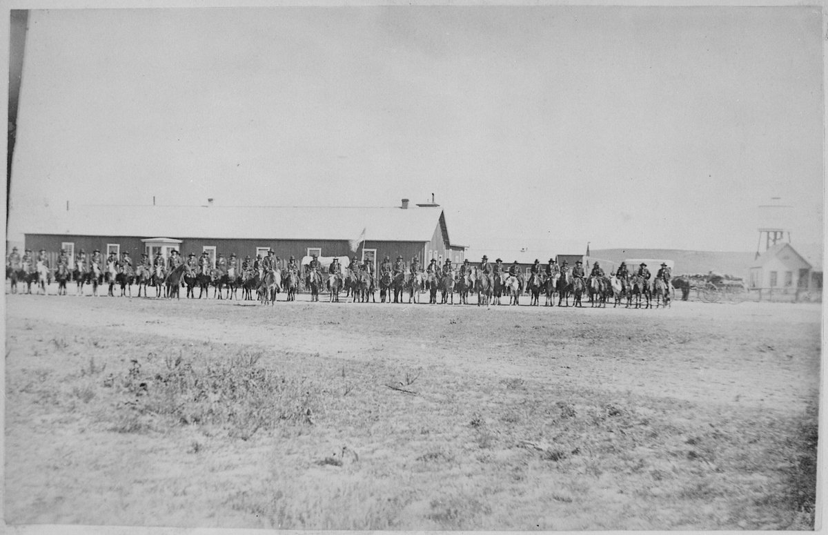 Sioux Indian police lined up on horseback in front of Pine Ridge Agency buildings, Dakota Territory, August 9, 1882