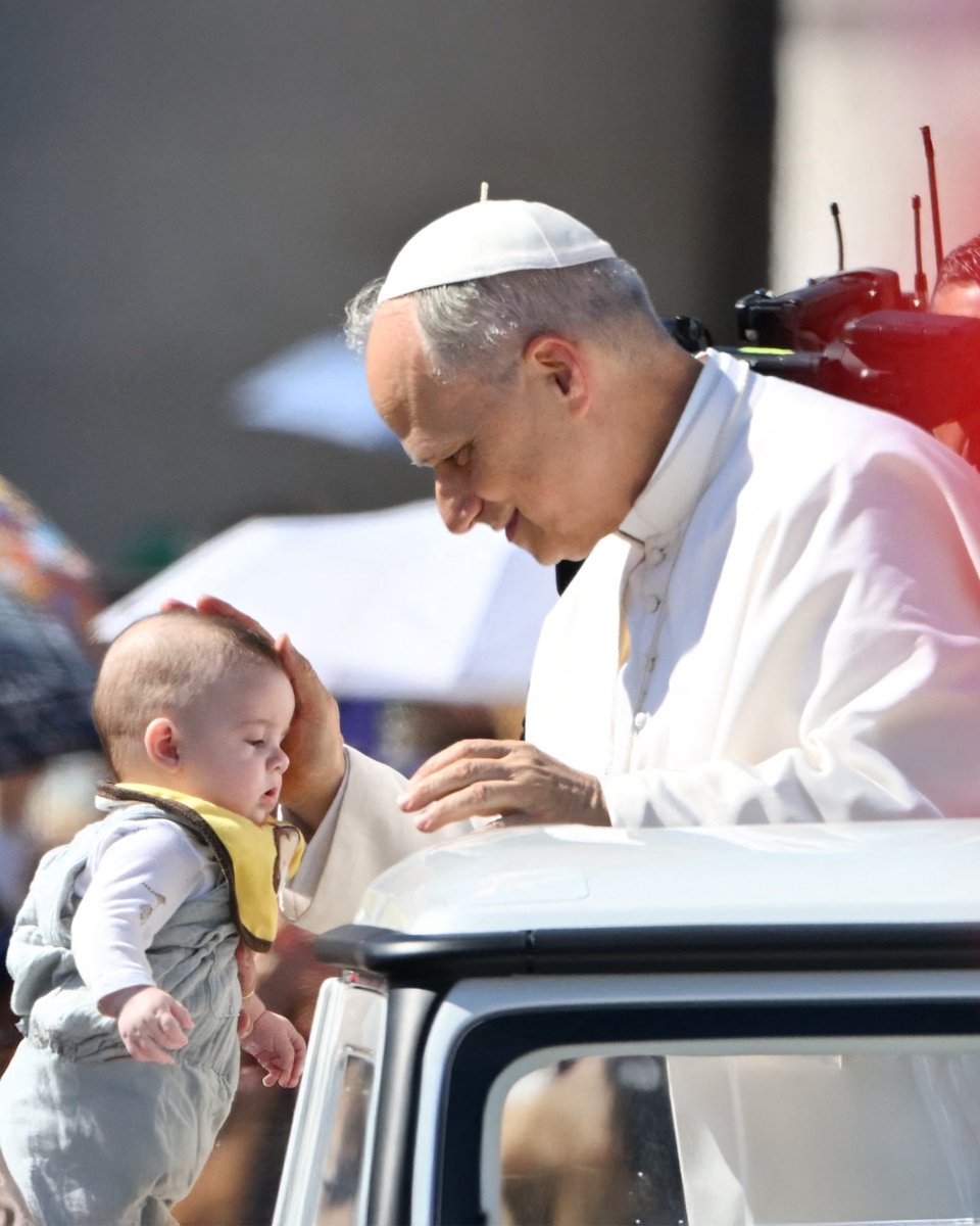 Pope Leo XIV blessing a child