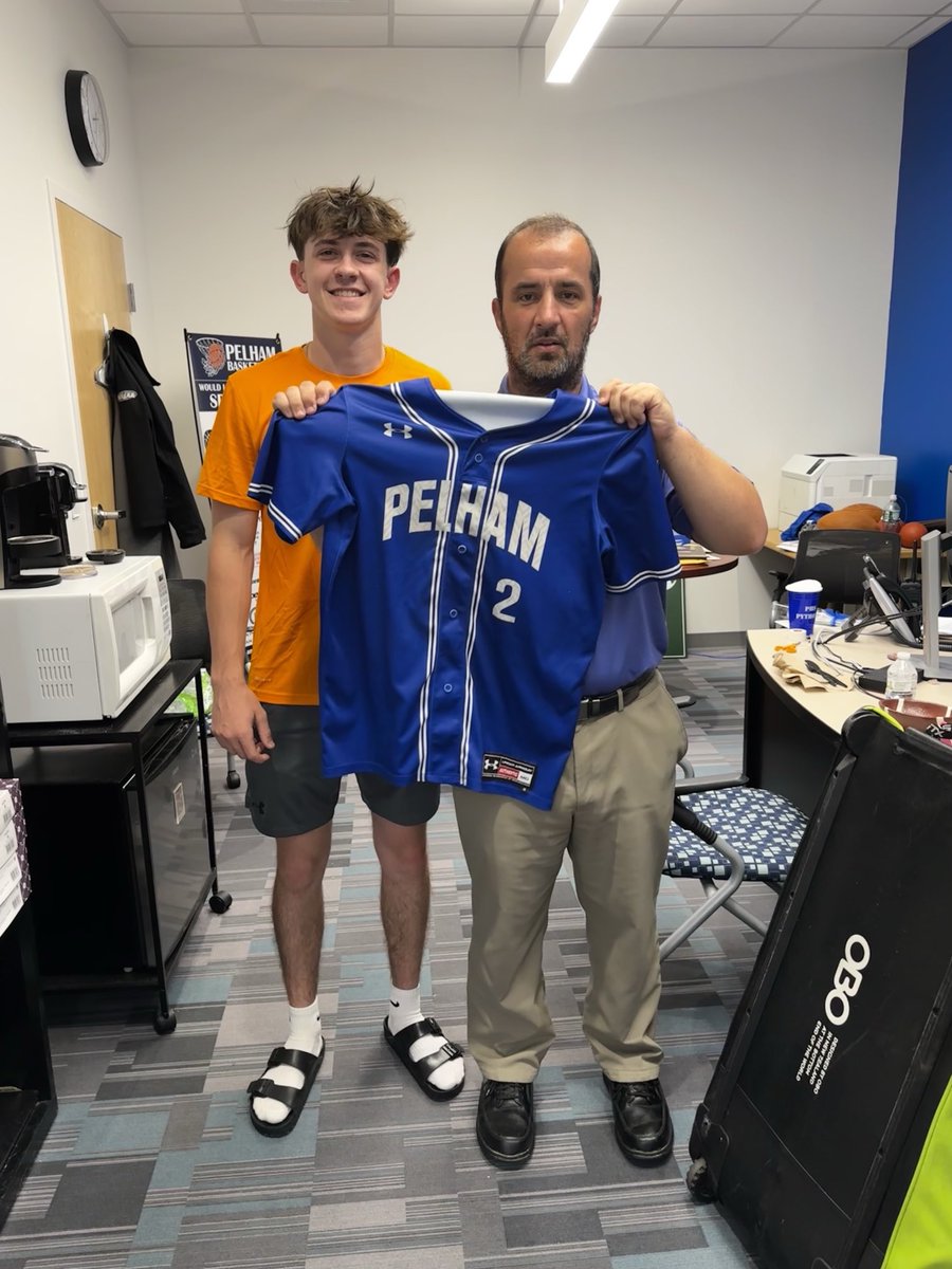 Pelham Baseball senior Justin Bowlan presenting his jersey and an appreciation card to AD Justin Hufft as part of the team’s “My jersey, your inspiration” program.