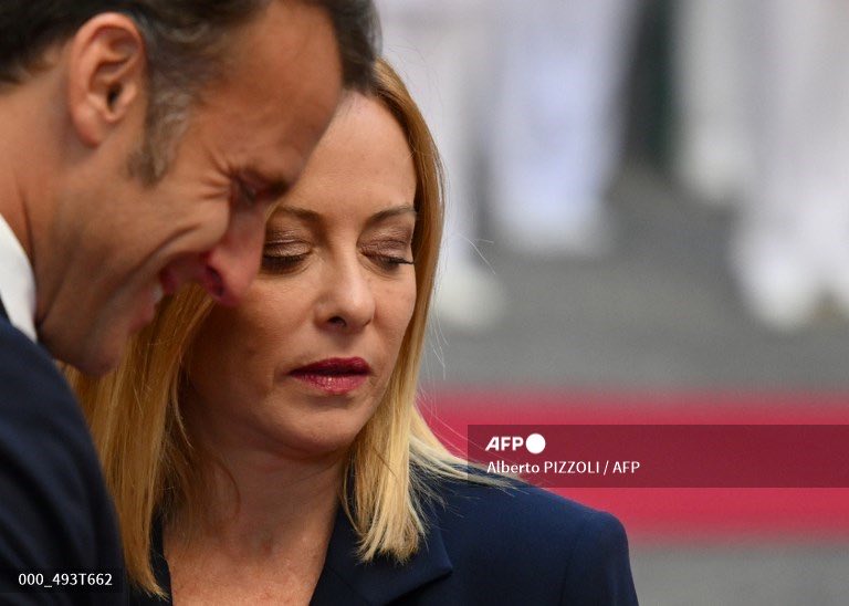 France's President Emmanuel Macron and Italy’s Prime Minister Giorgia Meloni react as they meet at Chigi palace in Rome