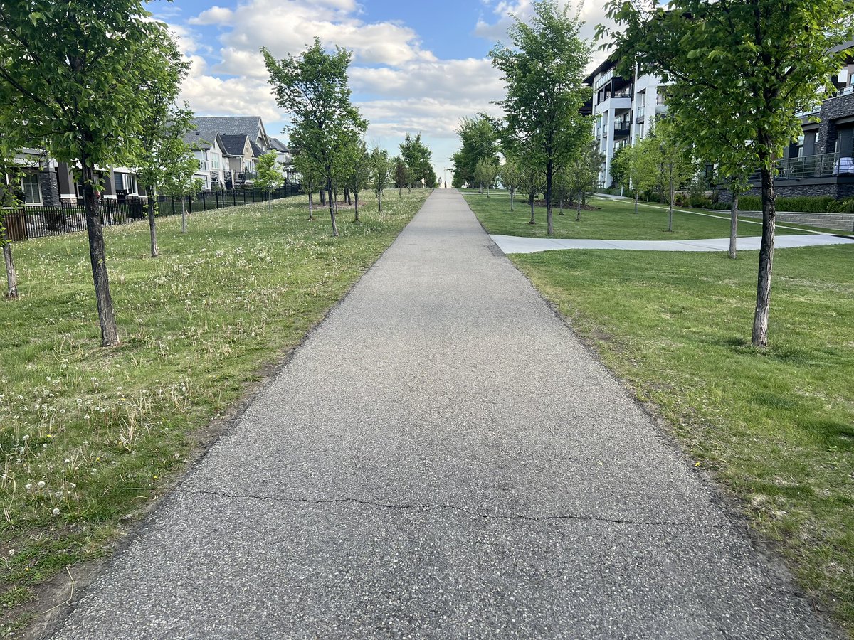 Welcome to Mahogany! One side of the path is managed by a private organization and one by the City of Calgary.