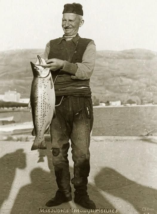 A moment of quiet triumph. Fisherman with Ohrid trout (Salmo letnica), Ohrid lake, Macedonia