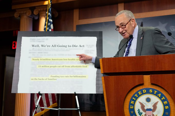 Senator Schumer stands with a sign that says “Well, We’re All Going To Die Act," June 4, 2025.