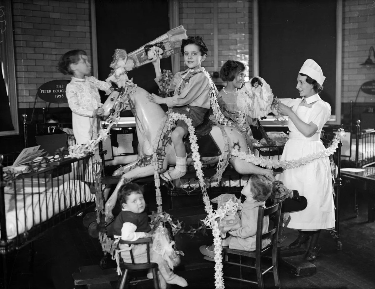 👻 Ghosts of Christmases Past 🎄

🎁 Festive joy at Great Ormond Street Hospital, London, as children gather around a large, garlanded rocking horse and a mound of Christmas presents in 1932.

Surrounded by toys, decorations, and a cheerful nurse, they enjoy a moment of Yuletide