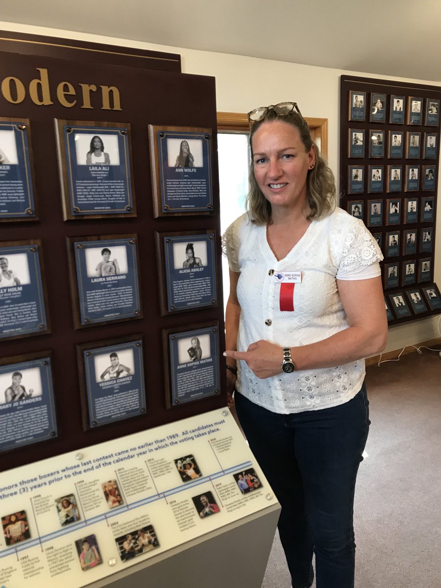 BoxingHall's tweet photo. 2025 Hall of Fame inductee Anne Sophie Mathis proudly points to her plaque on the Hall of Fame Wall! #boxinghalloffame https://t.co/TrQ5qEIJZJ