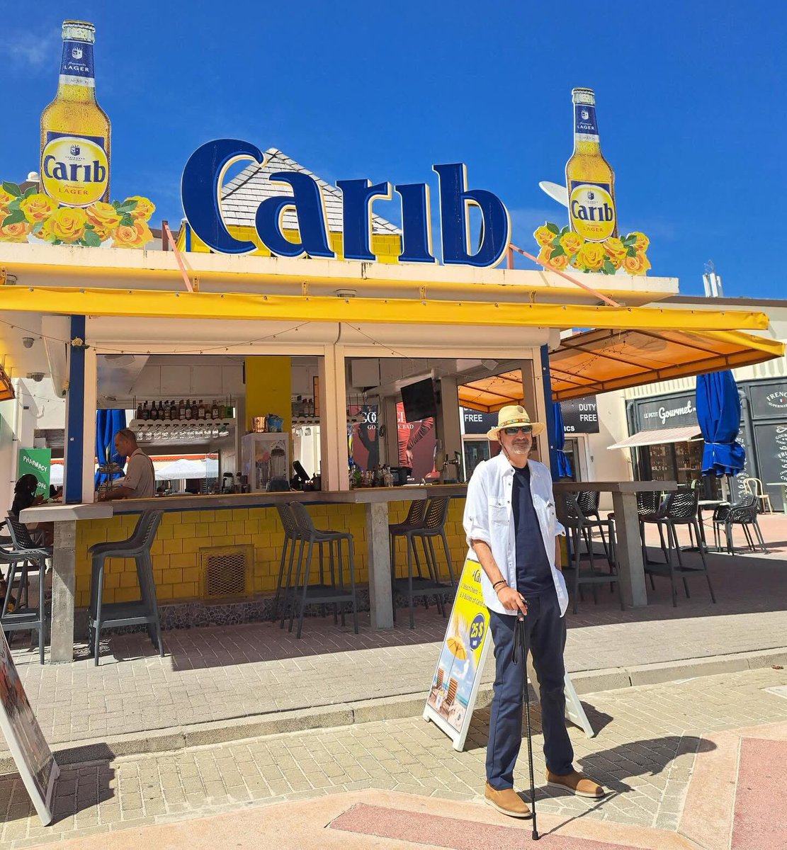 Here we are in #SXM doing a ‘Carib Ian’ thing on the boardwalk in Philipsburg.  Arrived today on the 10th Anniversary of my life-saving heart surgery. Just a quick stop on our way to a beach bar crawl in the #Caribbean . 😎 👅💦 <a href="/CaribBeerUSA/">CaribBeerUSA</a> <a href="/Thecaribbeer/">Carib Beer</a> <a href="/RealBeerIsCarib/">Carib Beer Grenada</a>