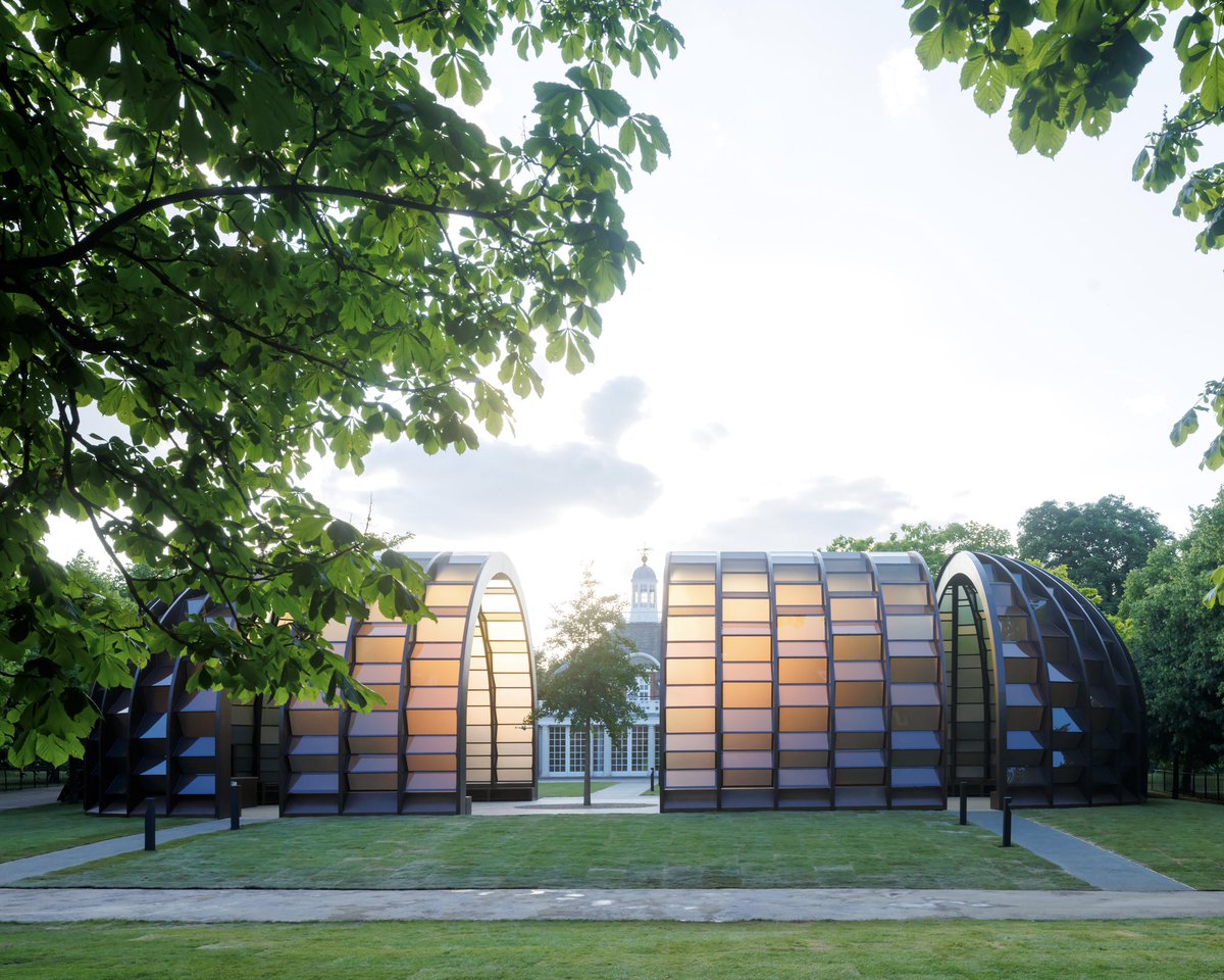 SerpentineUK's tweet photo. Now open! Serpentine Pavilion 2025: 'A Capsule in Time' by Marina Tabassum. 

Tabassum's Pavilion seeks to emphasise the sensory and spiritual possibilities of architecture. It's comprised of four wooden capsule forms featuring translucent panels that diffuse and dapple light. https://t.co/db8K8gVymT