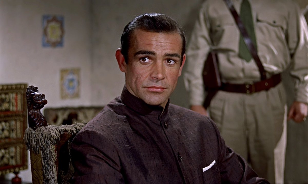 AarontYouGreat's tweet image. A few potential little homages in the #007FirstLight trailer I haven’t seen others mentioning:

While obviously a hotel staff disguise, the nehru jacket feels VERY like a nod to Dr. No.

We must have all noticed the chess game being based on FRWL, right?

(1/2)