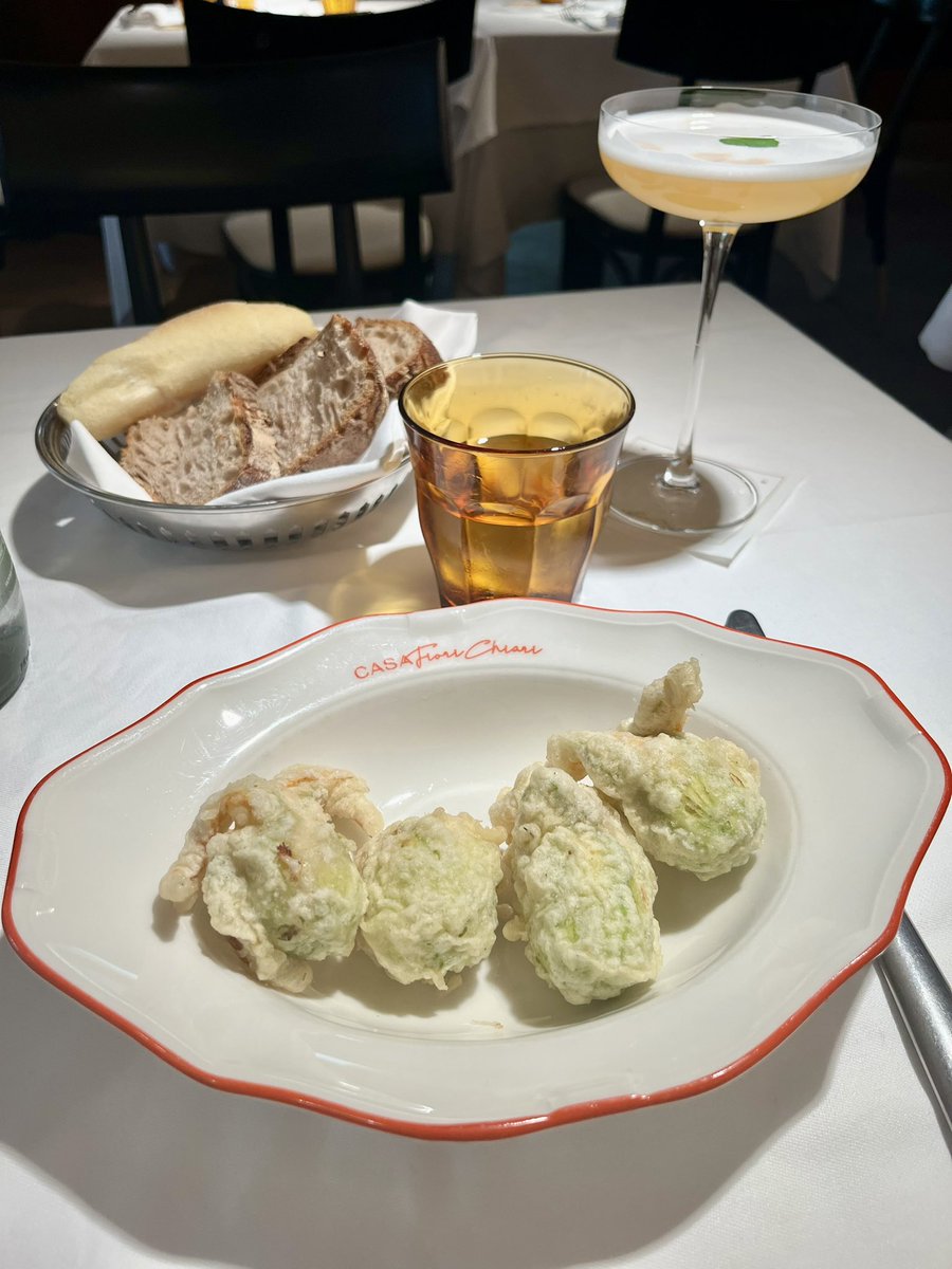 Sipping a cocktail in a Milanese restaurant whilst eating fried courgette flowers stuffed with ricotta, lemon, and anchovies. Heaven!