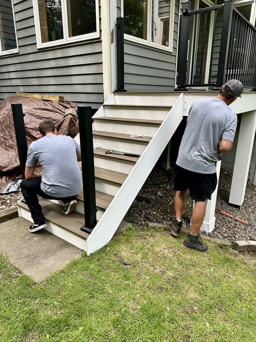 Putting the Finishing touches on this Maintenance Free Deck. Deckorators Dunewood with Westbury Aluminum Railing.