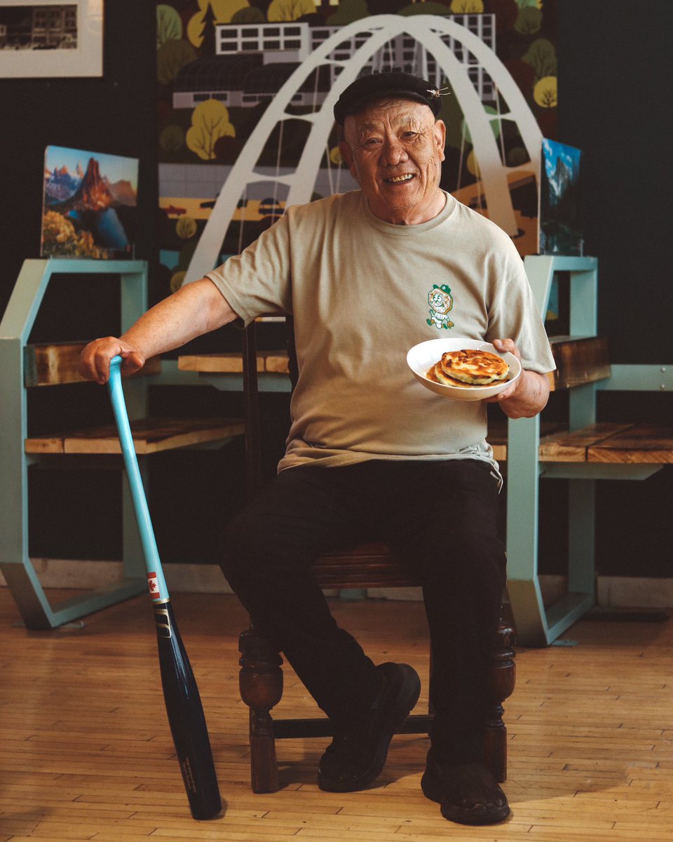 EdmRiverhawks's tweet photo. To complement our brand-new on-field Green Onion Cake jerseys, we’ve teamed up with local company @flannelfoxes to drop an exclusive tee!

The tee is modelled by none other than Siu himself—our friend &amp; the face behind the iconic Green Onion Cake Man restaurant on 118th Avenue. https://t.co/CTzTQkJHJX