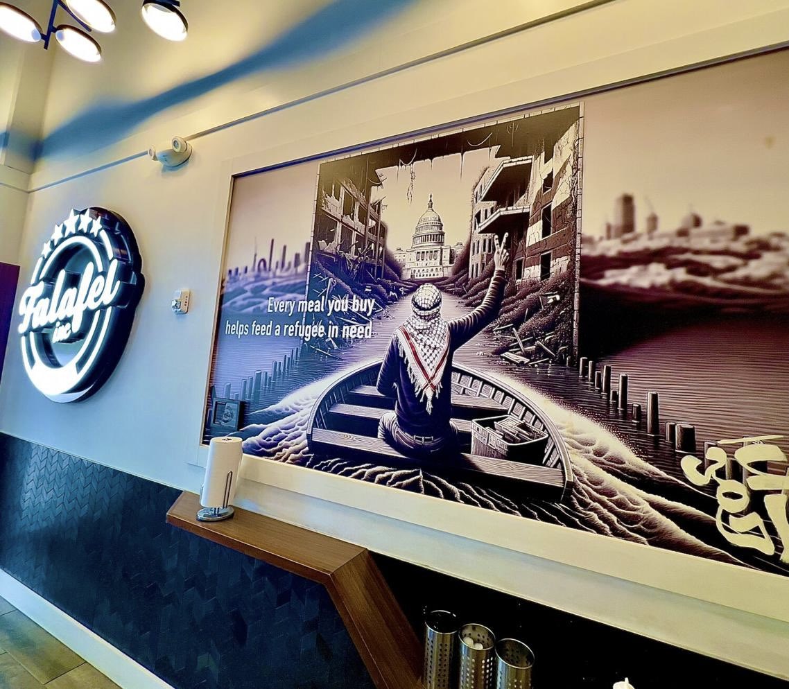 Alexandria VA - Falafel Inc. owner Ahmad Ashkar keeps up mural showcasing DC in ruins with a man in a keffiyeh standing on its demise. 

Post 10/7, the keffiyeh is often associated with violence against Jews.