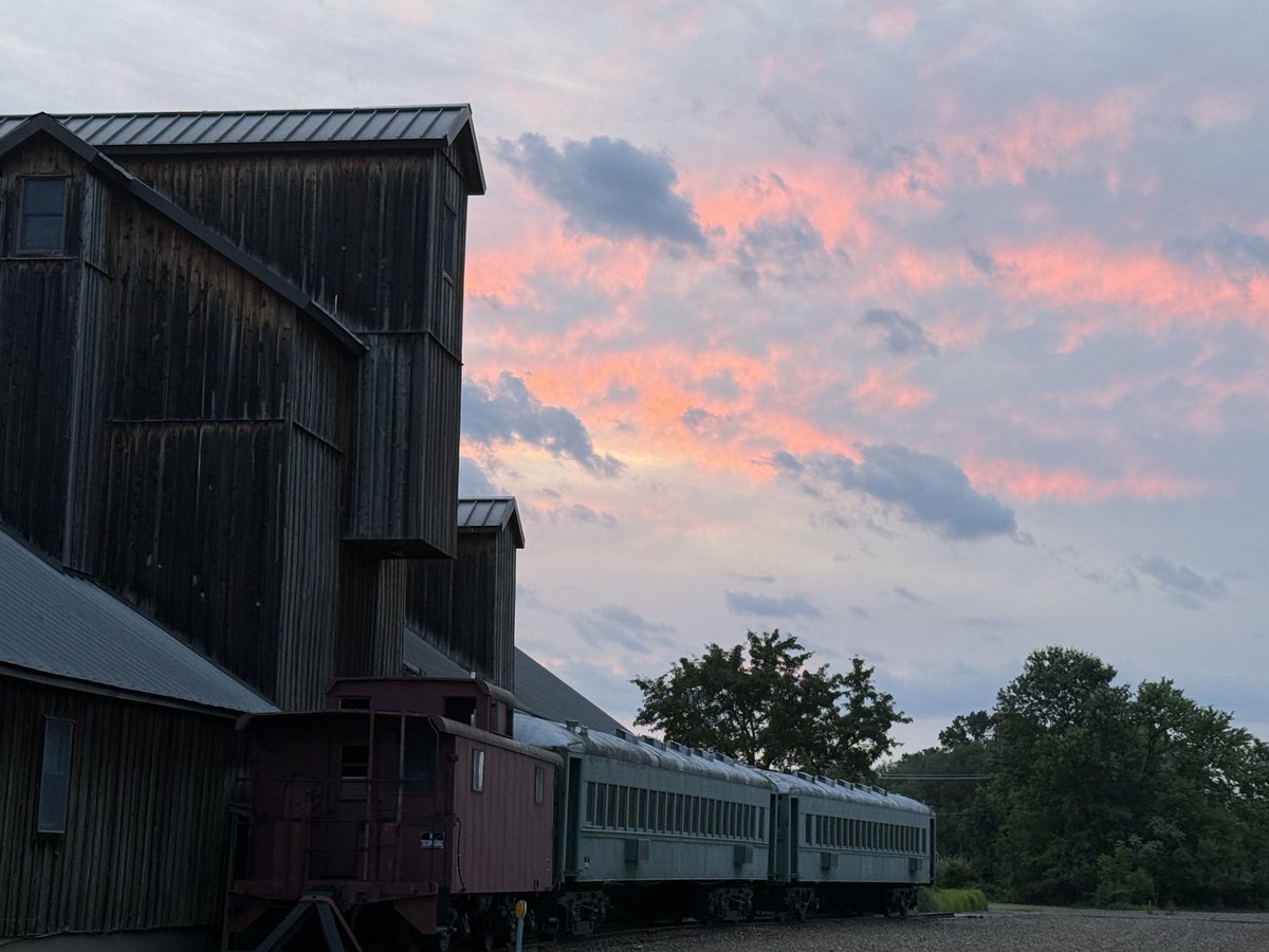 The skies unfurl in gentle gold,
Soft embers fading through the pine,
A painted hush where shadows hold
The Chesapeake and hills entwine.

Lavender ribbons stretch and gleam,
As day sighs into ocean’s air,
Each cloud a brushed and fragile dream,
Each breeze a song, light-scented