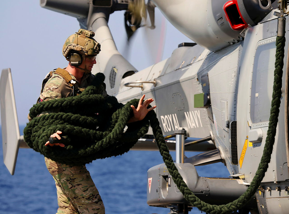 A Royal Marines Commando coils the 12-Strand Fast Rope, preparing it for the winchman to load onto the Wildcat HMA Mk2 after a sea exercise. 

The drill showcases the Royal Marines’ ability to swiftly deploy forces from the air in fast-paced maritime settings. 

Hovering above