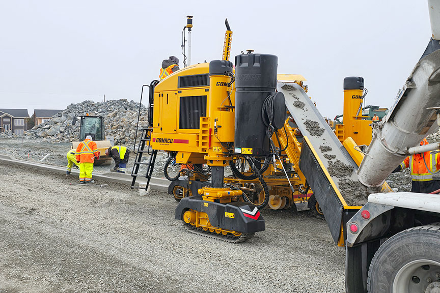 This Xtreme GOMACO GT-3600 with Topcon mmGPS guidance is simultaneously trimming and pouring curb and gutter in St. John's, Newfoundland, Canada. The mold is equipped with a California-style curb depressor and can block out existing driveways to eliminate wasted material.
#GOMACO