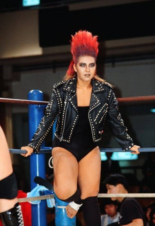 Wrong, it was HER. Bull Nakano did it first.

-Arena Mexico: June 5th, 1992 
-Tokyo Dome: November 11th, 1994 
-Madison Square Garden: August 25th, 1994
-Wembley Arena: September 14th, 1994