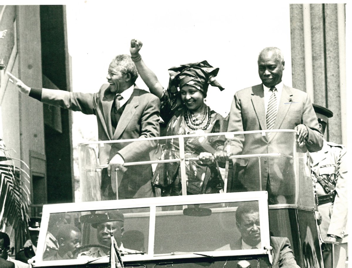 July 13, 1990 — Barely a few months after walking free from 27 years behind bars, Nelson Mandela rolled through Nairobi streets alongside his wife Winnie and President Moi in the back of Kenya’s iconic Land Rover. Mandela waved with hope, Winnie raised her fist like the