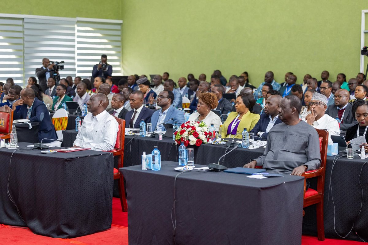 Can someone explain to me in detail the role of Baba Raila Odinga in this government?

I mean, how does he attend a cabinet retreat? Is he a member of the cabinet?

How does he sit next to the President on a Cabinet retareat? Is he among the leadership of the executive? 

Is