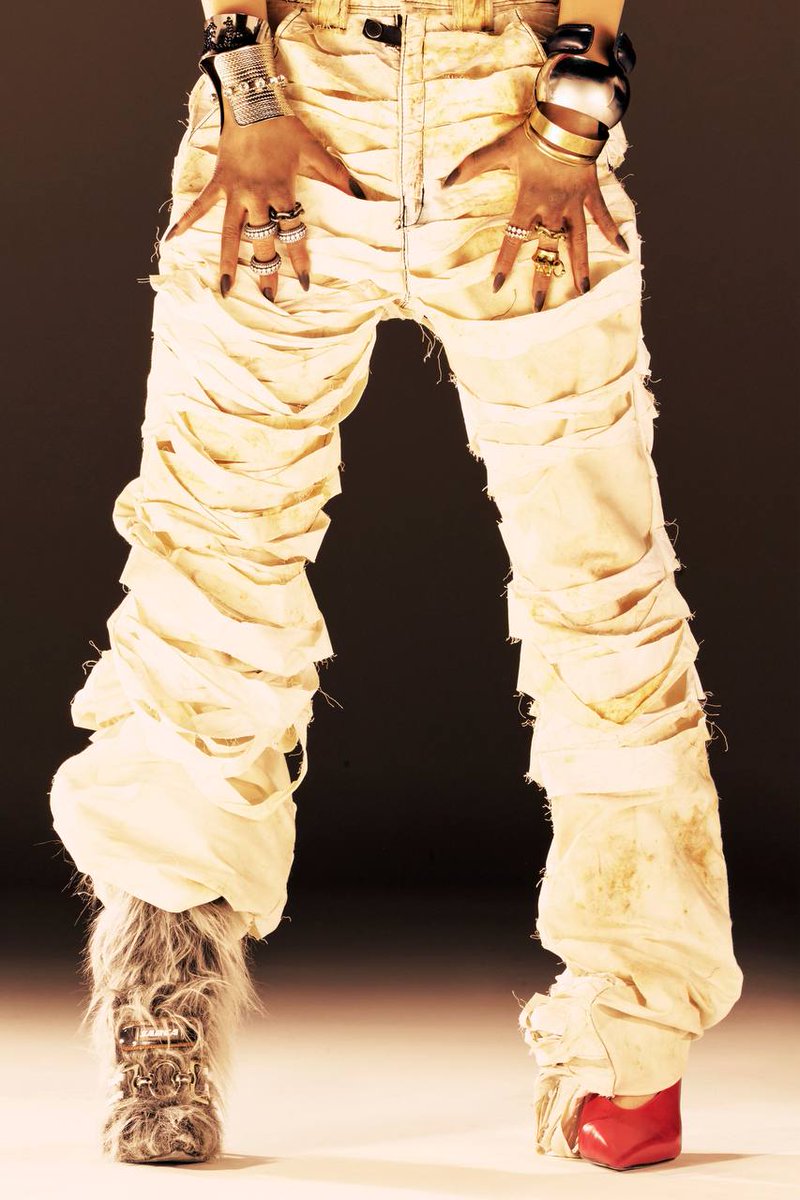 Theaescore's tweet image. Tattoo sharp like her tone. Eyes half shut like she’s already said too much. Gold stacked, hands loose, lips daring. She don’t chase spotlights—just burns hotter than them. Dirty’s not the work. Dirty is the standard.