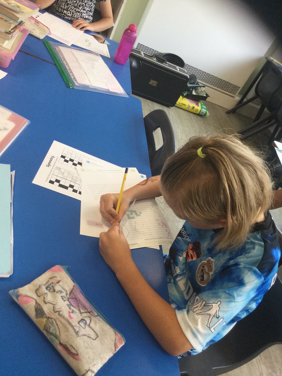 Year 3 and 4 hard at work this morning using mirrors to find lines of symmetry #STMMaths