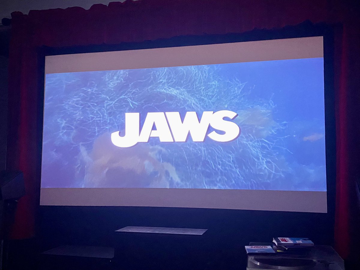 joefortunato's tweet image. Watching Jaws in my home theater today with my dog Hooper, dressed in his jaws T-shirt, me eating popcorn in my Jaws popcorn tin that I just got from the theater (while Hooper eats whatever falls on the floor! Lol) and it’s a perfect way to celebrate my favorite fish! 🦈🎬🎥🍿
