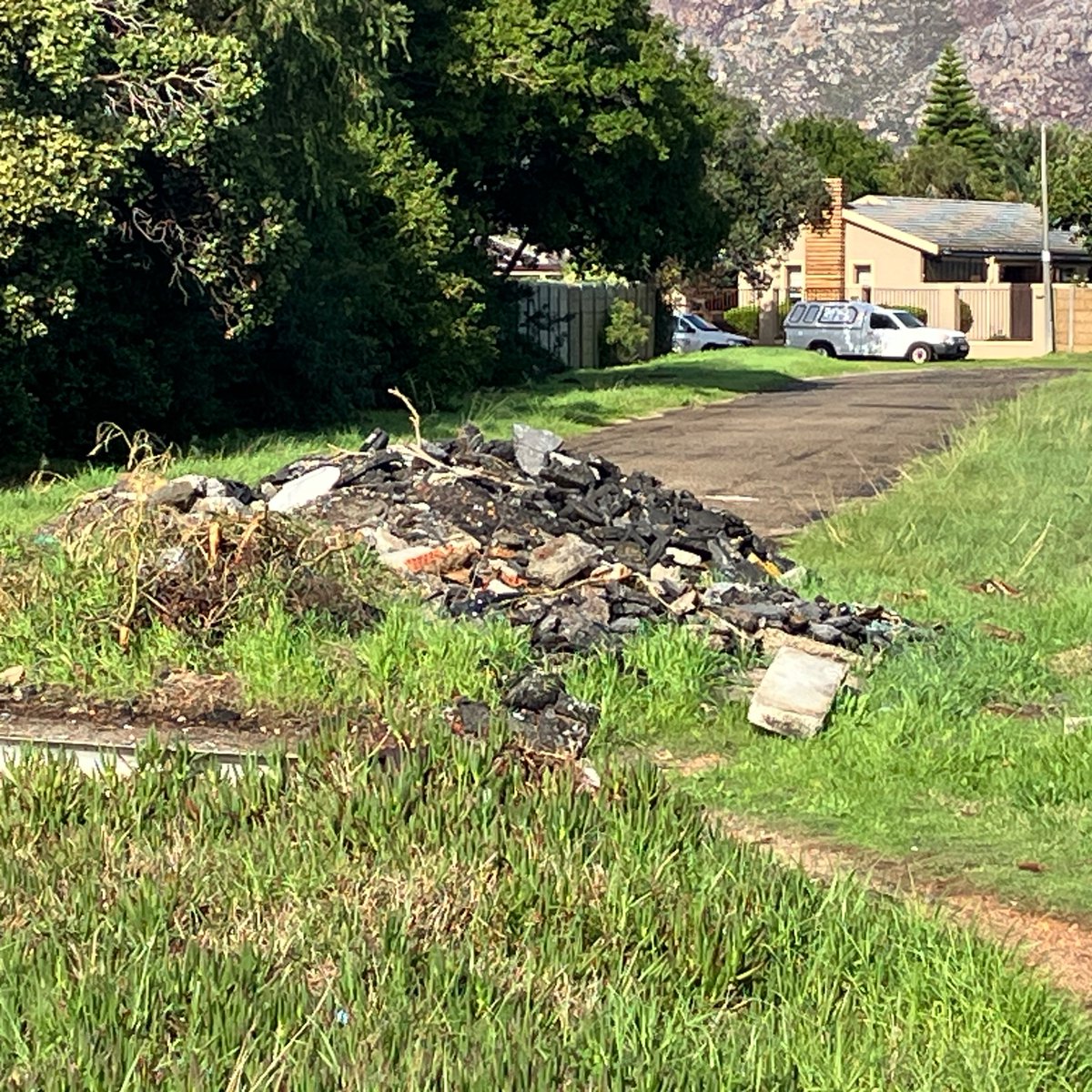 MichaelMee's tweet photo. @geordinhl @CityofCT weeks after roadworks in Tokai &amp; Kirstenhof this pile of rubble  remains (and it seems others are now adding to it). I logged a service request more than a week ago &amp; still no resolution. Has the K’hof neighbourhood become a dumping ground for the city? https://t.co/k70EZKFs04