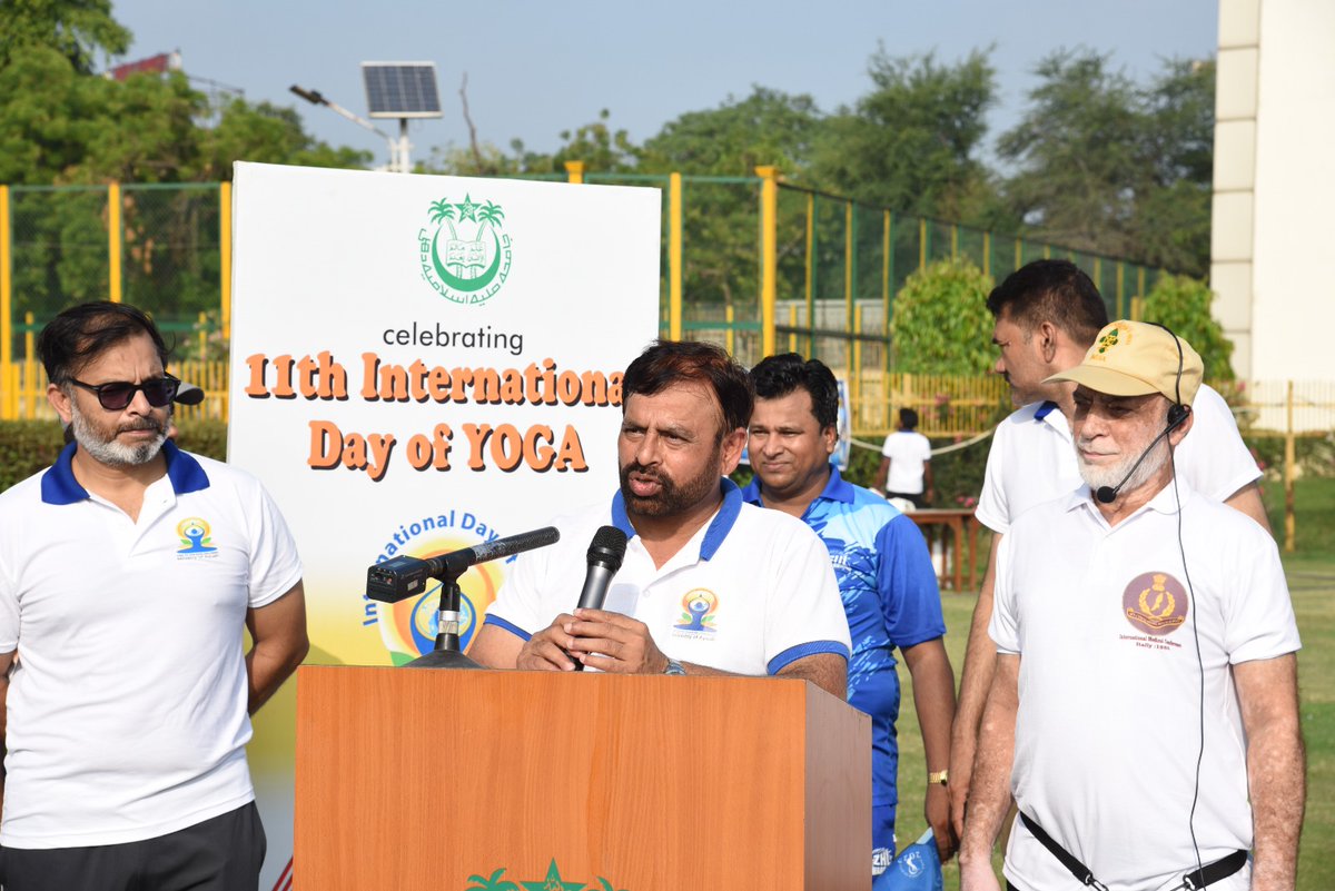jmiu_official's tweet photo. Jamia Millia Islamia celebrates IDY 2025 with tremendous enthusiasm and zeal

New Delhi, June 21, 2025.

Enthused by the Honourable Prime Minister Shri Narendra Modi's inspiring words, "Yoga is a pause button that humanity needs to breathe," thousands came together at Jamia Millia Islamia's (JMI) sprawling Sports Complex under the theme "Yoga for One Earth, One Health" to celebrate the 11th International Day of Yoga (IDY) 2025 under the leadership of Vice Chancellor, JMI, Prof. Mazhar Asif and Registrar, JMI, Prof. Md. Mahtab Alam Rizvi.

The grand celebration was organized by the Games & Sports Department, JMI, in collaboration with the Office of the Dean, Students’ Welfare, JMI. Thousands of teaching and non-teaching staff and students participated in International Yoga Day and witnessed the address of the Hon’ble Prime Minister of India. Thereafter, all the participants practiced yoga as per the protocol suggested by the Ministry of AYUSH, Government of India, under the supervision of Yoga Teacher/Guru Prof. (Dr.) Badrul Islam Kairanvi, Director, Institute of Dr. BIK Yoga & Clinic of AYUSH Paramedics, New Delhi & Former Training Commissioner, KVS BSG-Ministry of HRD, Govt. of India, New Delhi. The yoga teacher demonstrated various mudras and asanas to the participants, telling them about their specific values and importance in the healing process of various diseases and in maintaining bodily posture and flexibility.

Prof. Asif highlighted the importance of the rich and ancient tradition of yoga to attain a healthy mind, body, and soul. He urged the JMI community to fully integrate yoga into their daily lives. He stated, "Yoga is the best way to clean the heart and maintain a peaceful and harmonious self. Dil (heart) connects to our soch (thought), and the way to keep the mind and our thoughts pure is to keep the heart healthy."

Prof. Rizvi said, "The IDY will contribute to the fulfillment of the objective of Viksit Bharat.” He also said, “The entire JMI fraternity has been working tirelessly for the last one month, including attending several training sessions to make the International Day of Yoga 2025 a huge success. Regular yoga training sessions at JMI have instilled self-awareness and discipline among our faculty members and students."

Dean of Students' Welfare, Prof. Neelofer Afzal, Director, Sports and Games, Prof. Nafis Ahmad, the Controller and Deputy Controller of Examinations, the Chief Proctor and his team, Deans of Faculties, Heads of Departments, Directors of Centres, university faculty members and students, principals, teachers, and students of Jamia schools, NCC and NSS coordinators and their teams, and the Nasha Mukh Hostel committee, JMI (under the aegis of Nasha Mukht Bharat Pakhwada), came together in large numbers to participate in the IDY 2025.

A special radio program, produced by the AJK-Mass Communication Research Centre, JMI, was aired on Radio Jamia’s FM 90.4 on June 20, 2025, as an important segment of the commemoration of IDY 2025 at the university. Earlier, as part of pre-event activities, the Games & Sports Department, JMI, and the Department of Sanskrit, JMI, organized various  'Yoga Training Sessions/Workshops' in line with the preparation for the celebration of the 11th International Day of Yoga.

This year's grand yoga celebrations at JMI resonated with the Prime Minister's message, 'Sarve Bhavantu Sukhinah' that is, the happiness and well-being of all is a sacred responsibility, and yoga is one of the best ways to achieve it.

-Prof Saima Saeed 
Chief Public Relations Officer, JMI