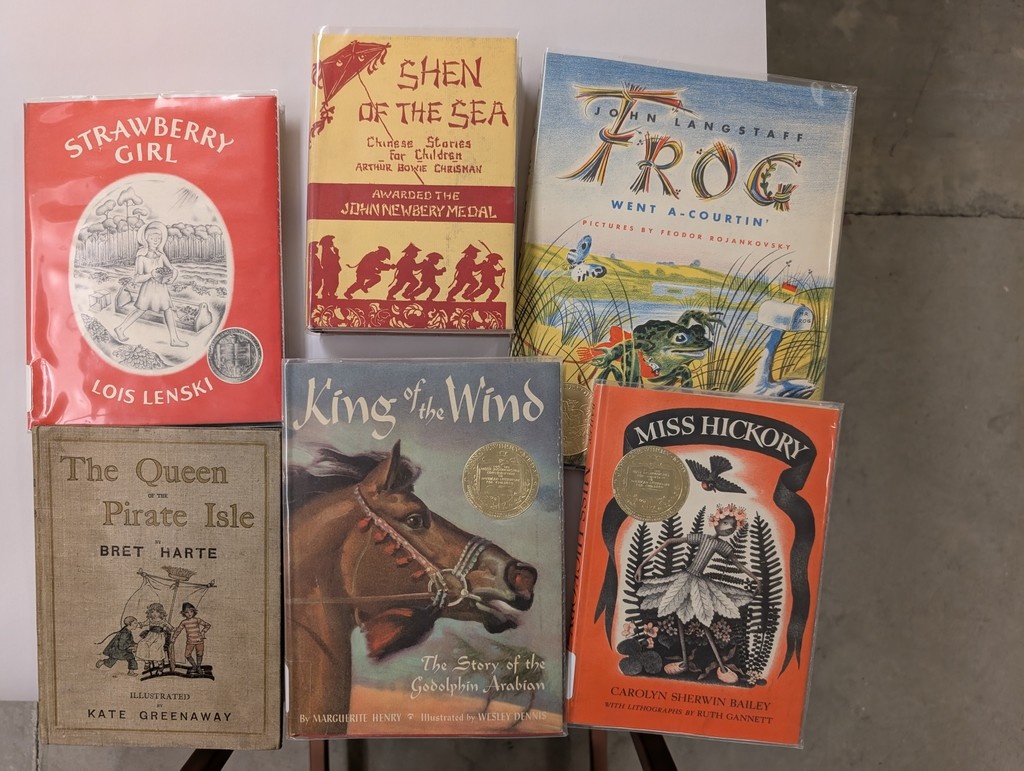 state_library's tweet image. Summer reading of yesteryear. These are but a sampling of the Newbery Medal-winning books housed at the Indiana State Library. Come see if we have your favorite. Also, read more about the influential Mr. Newbery here: tinyurl.com/ycf7bbrf #books #SummerReading #Newbery