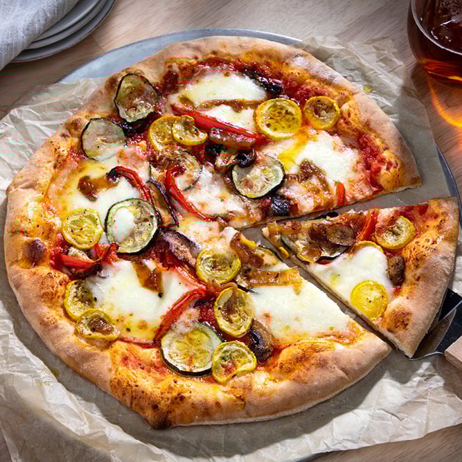 Introducing June’s Pizza of the Month, Il Giardino!

This veggie pizza features homemade pizza dough topped with red sauce, fresh mozzarella, roasted vegetables including zucchini, eggplant, squash, and bell peppers, and then finished off with oregano, sea salt, and olive oil.