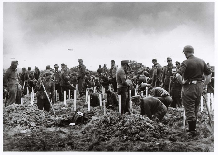 kershaw_alex's tweet image. Gravediggers. Robert Capa's incredible photo of POWs burying Americans killed on Omaha Beach in the first American graveyard, just off the beach.