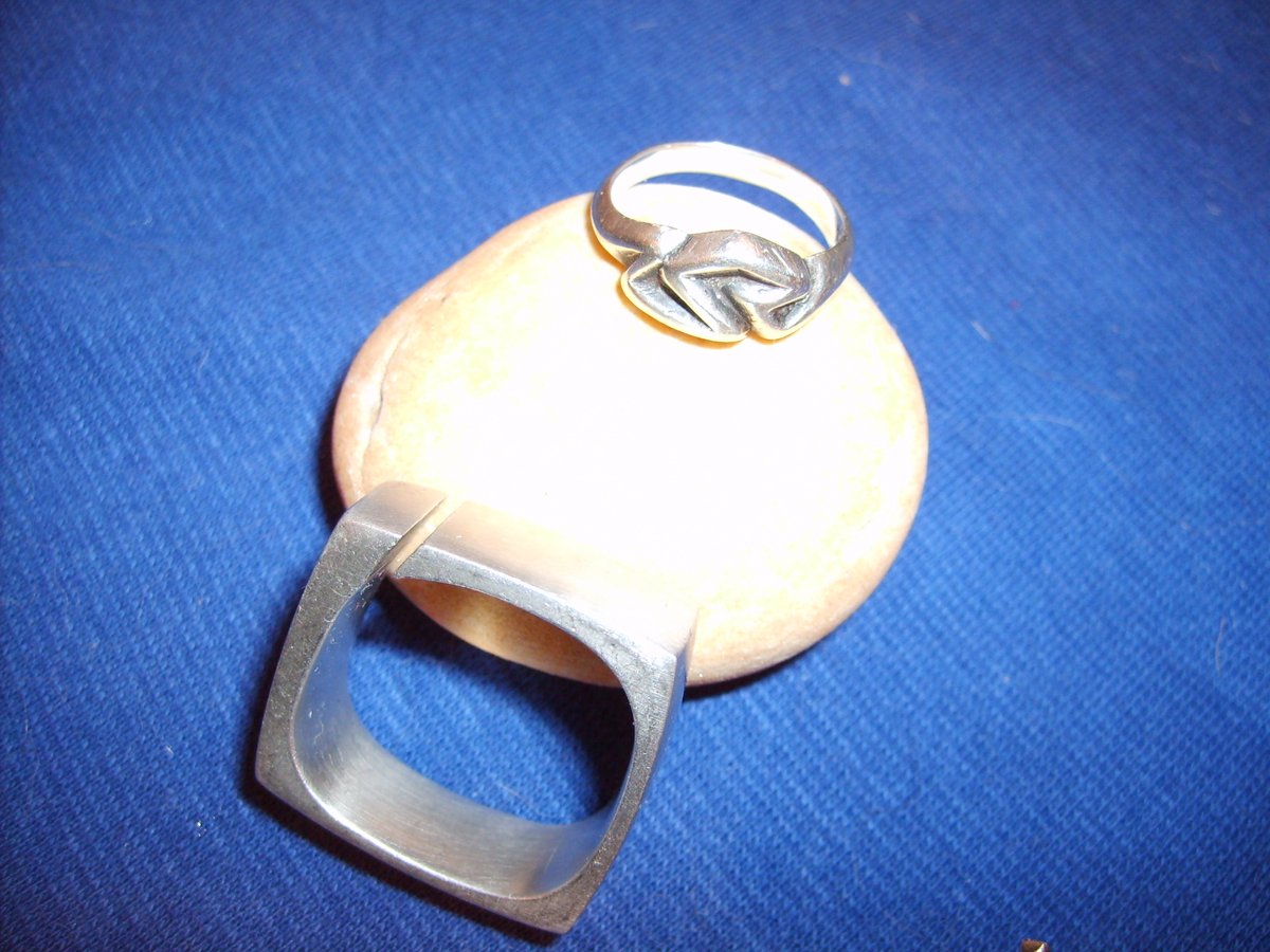 Jewelry! A study of a square ring in aluminum, which later led to Harry's own wedding ring. His wedding ring, a size 13, in gold, sat in his dresser drawer because he did not want it to get in the way while working. His hands continued to grow larger as he used them.