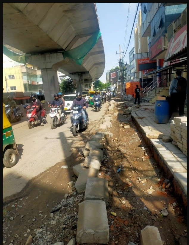 Brand Bangalore, in one image. A flyover that's been delayed 10 years one one side and a footpath that's going to be in shambles come September. A tree that used to be there, now not even a memory.
