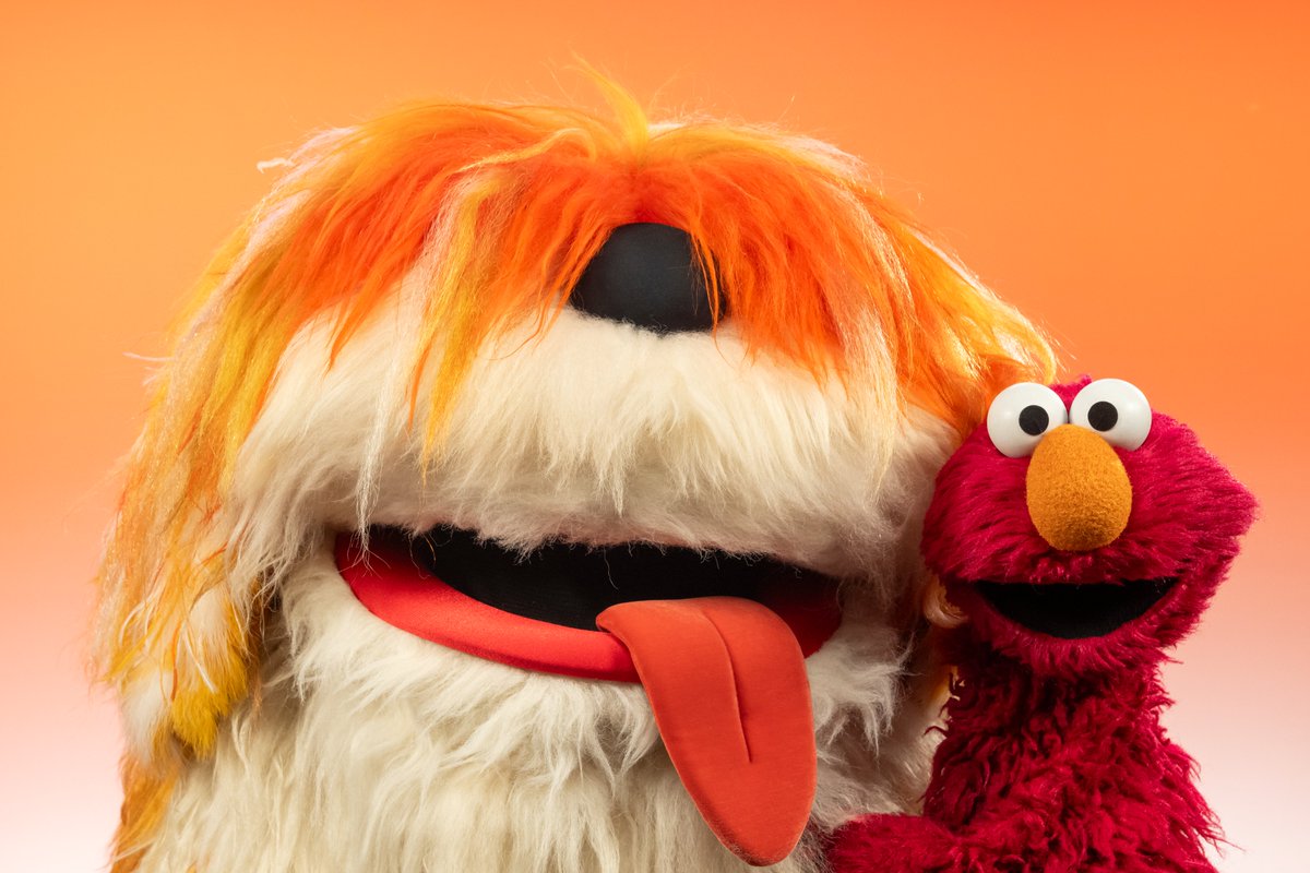 elmo's tweet image. Elmo needed a big doggy hug today so of course Elmo knew exactly which doggy to call. Ha ha ha! Elmo loves you, Barkley! #GiftOfGiggles